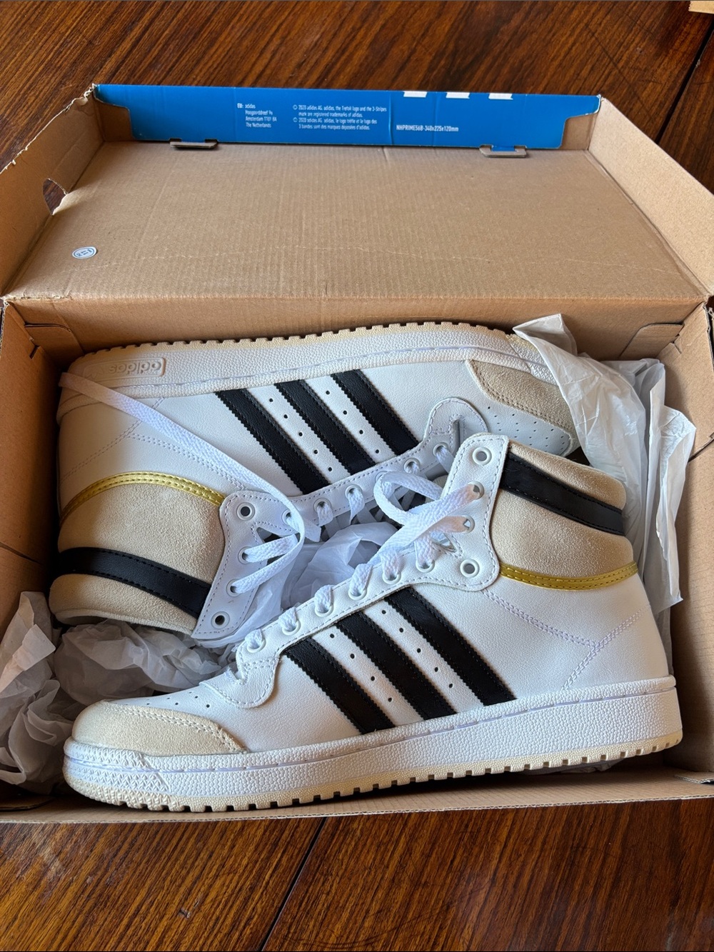 adidas White High-Top Sneakers with Black Stripes and Gold Accent